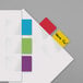 A white folder with Redi-Tag color sticky page flags in yellow, blue, green, purple, and red.