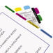 A close-up of a file folder with Redi-Tag Write-On colorful tabs.