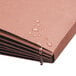 A Smead redrope expansion wallet on a brown surface with water droplets.