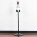 A black Marco Company floor mount produce bag stand.