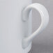 A close-up of a Schonwald white porcelain mug with a handle.