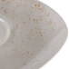 A light gray Schonwald porcelain saucer with brown speckles.