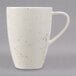 A white Schonwald porcelain mug with brown speckled spots and a unique design on it.