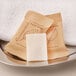 An Ecossential Naturals facial soap bar with a leaf on it on a silver tray.