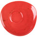 A Schonwald red porcelain saucer with a round shape and a circle in the middle.