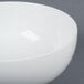 A CAC porcelain salad bowl with a small rim on a gray surface.