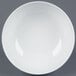 A bright white porcelain salad bowl with a white rim.