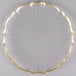 A glass Charge It by Jay plate with a scalloped clear surface and a gold rim.