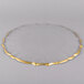 A close-up of a Charge It by Jay clear glass charger plate with a gold edge.