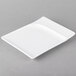 A white rectangular porcelain platter with contoured edges.