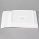 A rectangular white porcelain platter with contoured edges.