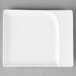 A rectangular white porcelain platter with contoured edges.