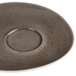 A dark gray Schonwald porcelain saucer with a small circle on the bottom.