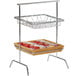 A Clipper Mill chrome plated iron 2-tier basket stand with food in it.