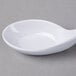 A white spoon on a white bowl.