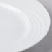 A close-up of a Schonwald white porcelain platter with a wavy design.