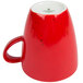 A red Schonwald porcelain cup with a speckled design.