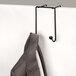 A Fellowes black wire double-garment hook holding a coat.