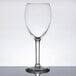 A clear Libbey tall wine glass with a stem on a table.