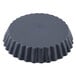 A black round Matfer Bourgeat fluted quiche mold.