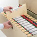 A person opening a file cabinet with a Smead legal size file.