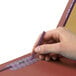A person holding a purple Smead SafeSHIELD legal size classification folder with a pen.