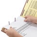 A hand holding a proposal document using a Smead SafeSHIELD Legal Size Classification Folder.