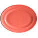 A coral oval Tuxton china platter with a white background.