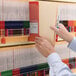 A person holding a Smead Shelf-Master file folder with a bunch of file folders.