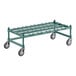 A green metal rack with black wheels.