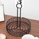 A black wrought iron Choice condiment caddy with card holder on a table.