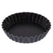 A black fluted Matfer Bourgeat tartlet mold.