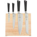 A Mercer Culinary Z&#252;M&#174; knife set on a wooden block.