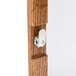 A close-up of a wooden door handle with a metal lock.