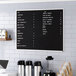 An Aarco black felt open face message board on a wall.