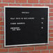 A black Aarco open face message board with white text on it.