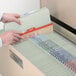 A person's hands opening a file drawer filled with Smead letter size classification folders.