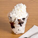 A WNA Comet classic sundae cup of ice cream with chocolate syrup and a spoon.