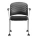 A black Eurotech office side chair with wheels and a white back.