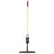 A Rubbermaid Light Commercial 18" Spray Mop with a yellow and red handle.