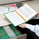 A man holding a Smead file folder with papers.