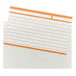 A close-up of a white paper with a white and orange lined index card in a clear poly pocket.