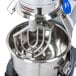 A Vollrath flat beater attached to a mixer with a bowl inside.