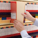 A person holding a Smead heavy weight letter size classification folder.