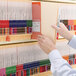 A person holding a Smead Shelf-Master file folder with a file inside.