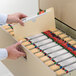 A hand opening a file drawer to reveal Smead file jackets.