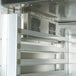 A Traulsen single section stainless steel reach-in freezer with shelves and doors.