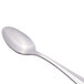 A Libbey stainless steel demitasse spoon with a silver handle.