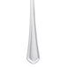 A close-up of a Libbey stainless steel serving spoon with a white handle.