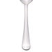 A Libbey stainless steel serving spoon with a white handle.